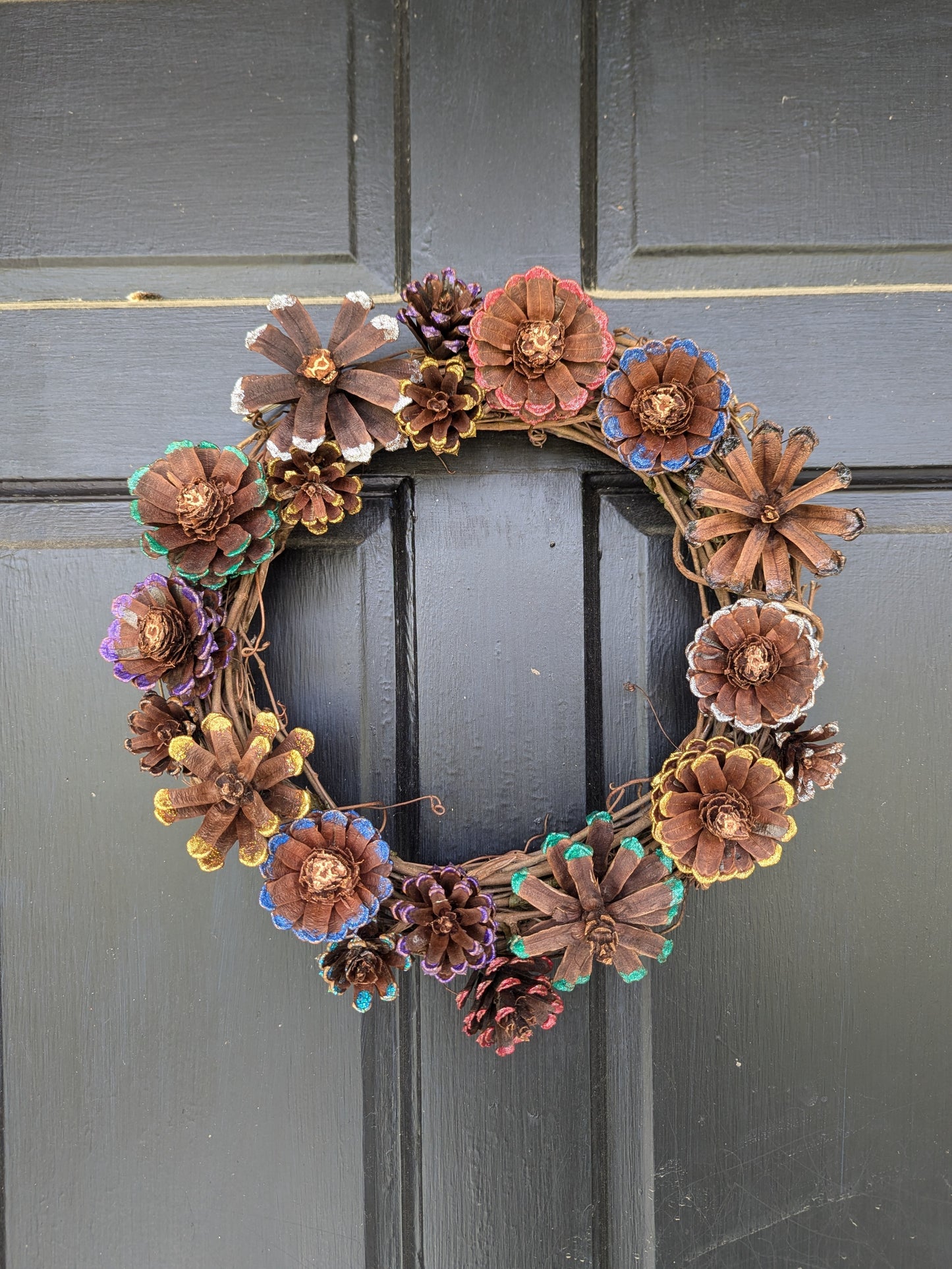 Custom wreath with glitter painted flower pinecones